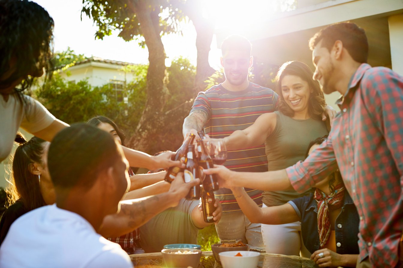 Cheerful friends toasting drinks in party